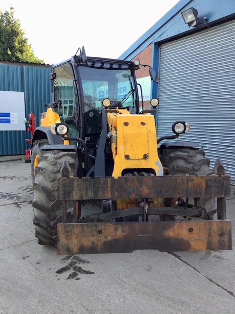 A Dieci T80 Pivot Steer Telehandler parked in front of a building.