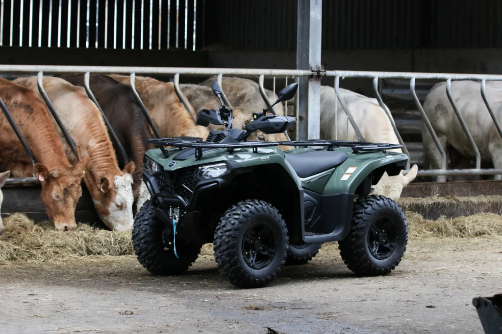 ATV in a barn with cattle feeding nearby